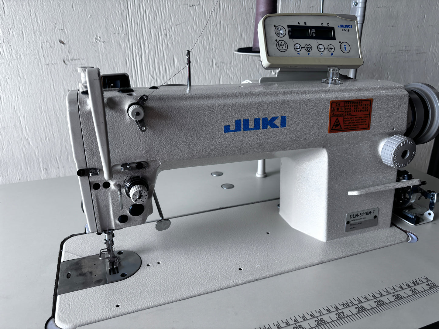 Pre-owned Juki DLN 5410N-7 needle feed lockstitch sewing machine